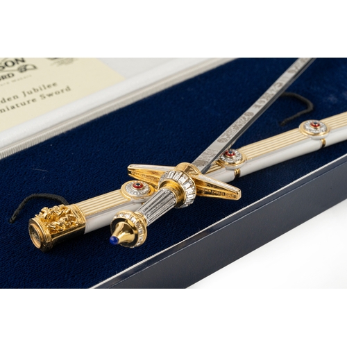 150 - A Wilkinson Sword Golden Jubilee Miniature Sword  

An ornate cross hilted sword to commemorate HM Q... 