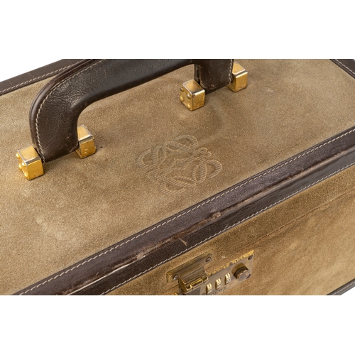 159 - A Loewe Suede Travel Bag 

A Loewe travel bag, in rich brown suede, with the brand’s logo, accents a... 