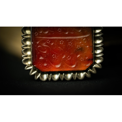 13 - A RECTANGULAR FORM SILVER FRAMED AGATE PENDANT Of square form, Arabic inscription engraved in nas’ta... 