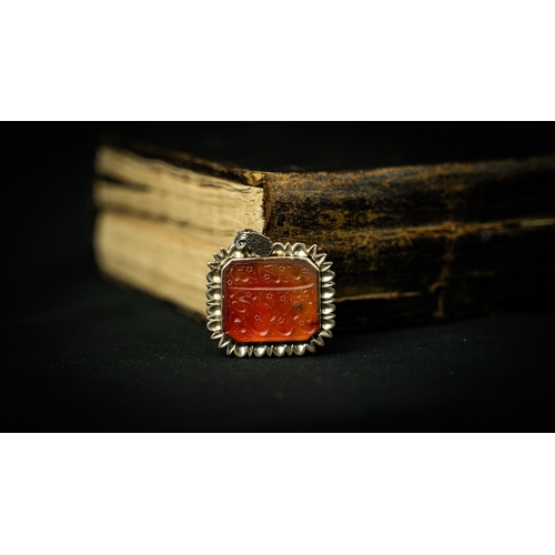 13 - A RECTANGULAR FORM SILVER FRAMED AGATE PENDANT Of square form, Arabic inscription engraved in nas’ta... 