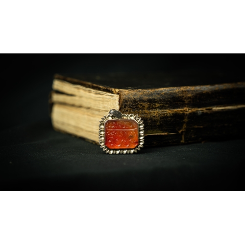 13 - A RECTANGULAR FORM SILVER FRAMED AGATE PENDANT Of square form, Arabic inscription engraved in nas’ta... 