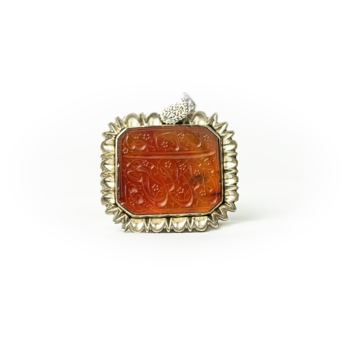 13 - A RECTANGULAR FORM SILVER FRAMED AGATE PENDANT Of square form, Arabic inscription engraved in nas’ta... 