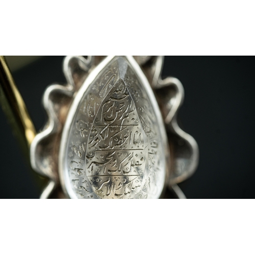 21 - A DROP FORM ENGRAVED ROCK CRYSTAL PENDANT, IRAN Of tear shape, the crystal surface engraved with Ara... 