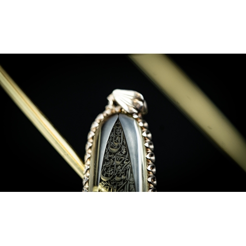 22 - AN ELONGATED DROP INTAGLIO PENDANT Of elongated oval form, the rock crystal surface engraved in Arab... 