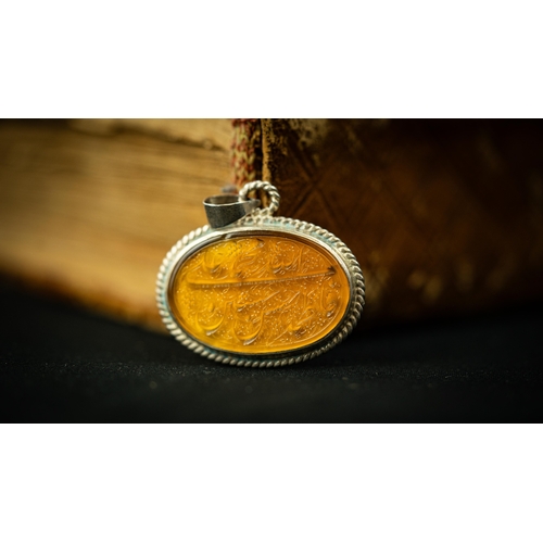 26 - AN AGATHE PENDANT Of oval design, the agate surface engraved with Persian nastaliq inscription with ... 