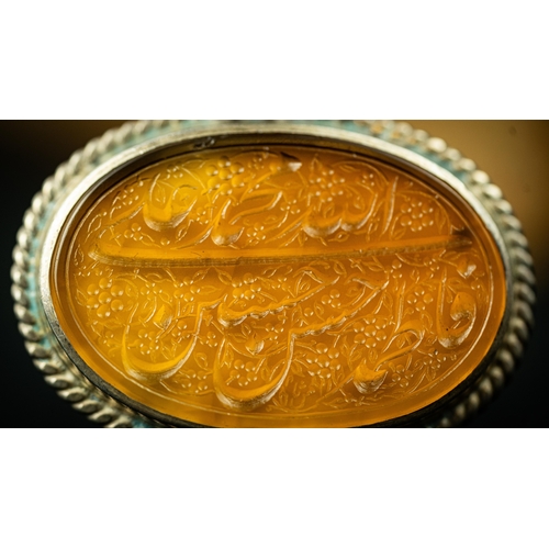 26 - AN AGATHE PENDANT Of oval design, the agate surface engraved with Persian nastaliq inscription with ... 