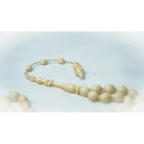 52 - A BONE PRAYER BEADS, The tasbih strung  with 33 bone ovoid  beads, flat stops, narrowing and nicely ... 