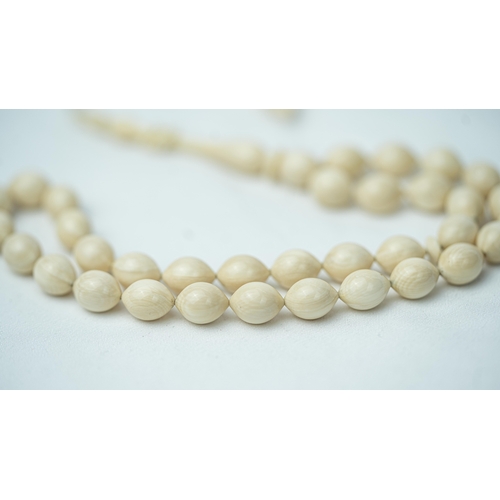 52 - A BONE PRAYER BEADS, The tasbih strung  with 33 bone ovoid  beads, flat stops, narrowing and nicely ... 