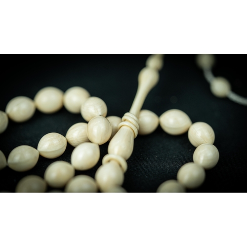 52 - A BONE PRAYER BEADS, The tasbih strung  with 33 bone ovoid  beads, flat stops, narrowing and nicely ... 