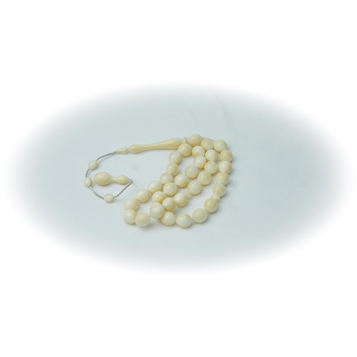 53 - A BONE PRAYER BEADS, The tasbih strung  with 33 bone spherical  beads, flat stops, narrowing and  el... 