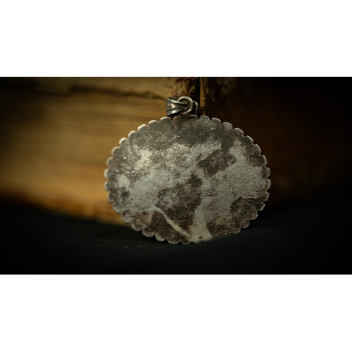 6 - AN OVAL FORM SILVER FRAMED AGATHE PENDANT Of oval form, an engraved cartouche in the centre with Qur... 