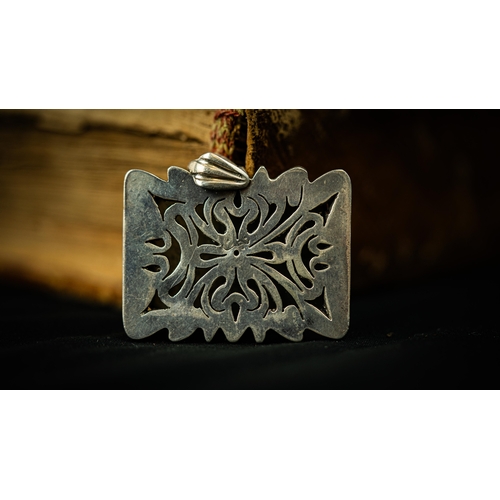 7 - A RECTANGULAR FORM SILVER FRAMED GREEN JADE PENDANT Of square form, the jade surface engraved with A... 