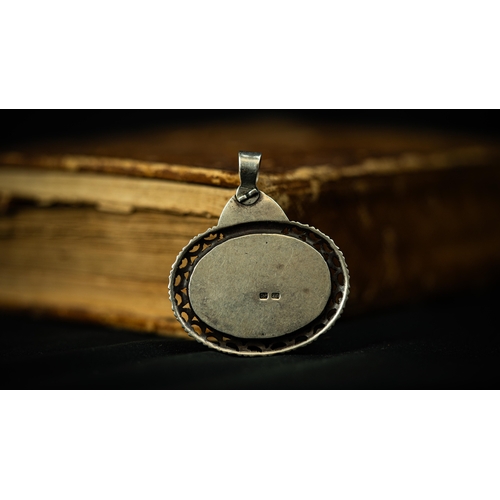 9 - AN OVAL FORM SILVER FRAMED DOMICAL AGATHE PENDANT, IRAN, SHIRAZ Of oval form, Arabic inscription (Su... 