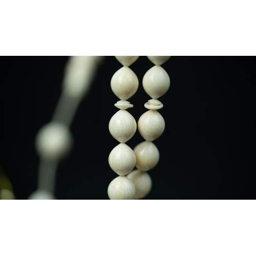 56 - BONE PRAYER BEADS, The tasbih strung  with 33 bone ovoid  beads, flat stops, narrowing and  stylised... 