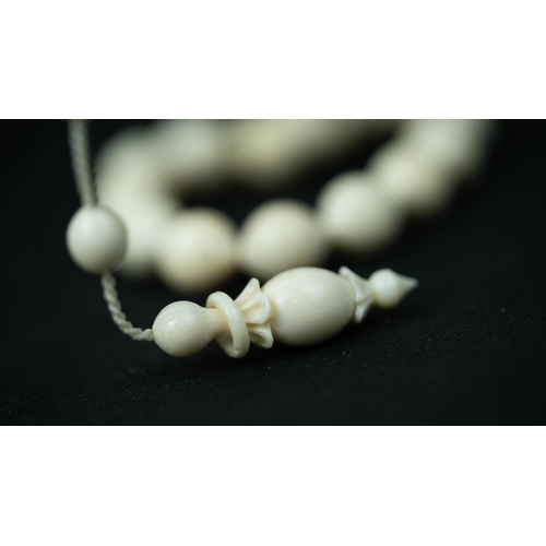 56 - BONE PRAYER BEADS, The tasbih strung  with 33 bone ovoid  beads, flat stops, narrowing and  stylised... 