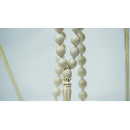 56 - BONE PRAYER BEADS, The tasbih strung  with 33 bone ovoid  beads, flat stops, narrowing and  stylised... 