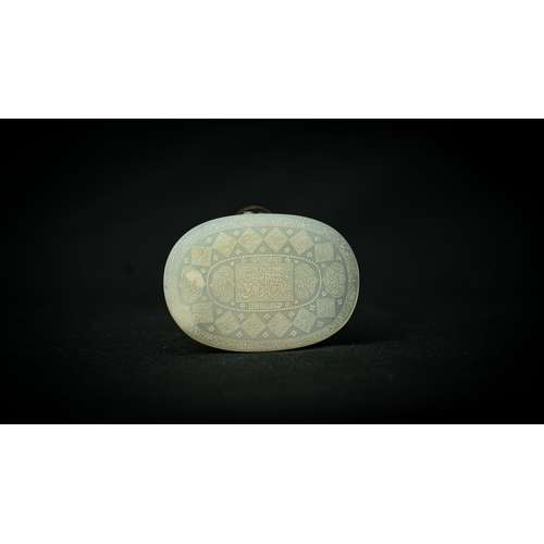 101 - AN OVAL WHITE TALISMANIC STONE, Of oval shape, talismanic stone featuring carved Arabic inscriptions... 