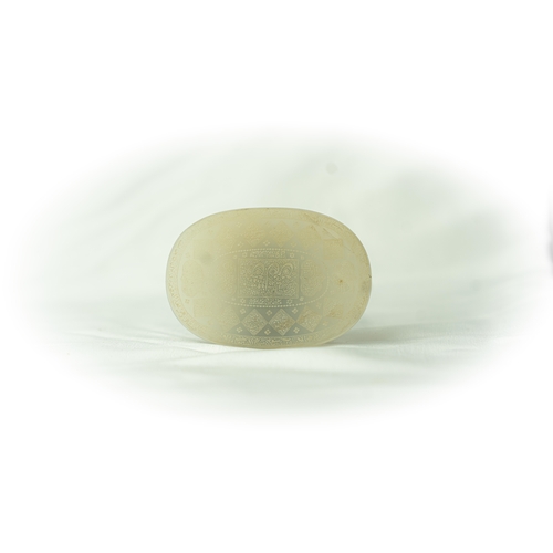 101 - AN OVAL WHITE TALISMANIC STONE, Of oval shape, talismanic stone featuring carved Arabic inscriptions... 