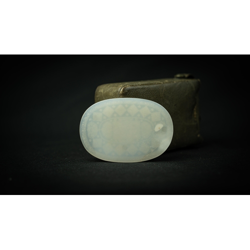 101 - AN OVAL WHITE TALISMANIC STONE, Of oval shape, talismanic stone featuring carved Arabic inscriptions... 