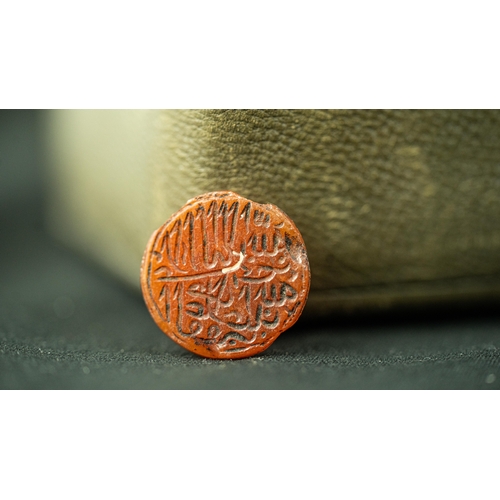 104 - AN ARABIC INSCRIPTION CARVED TINY CORNELIAN STONE, Of circular form, Arabic inscription carved front... 