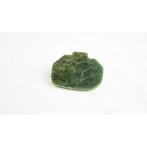 107 - A SPINACH GREEN JADE PENDANT, Of rectangular form, Persian inscription against a background decorate... 