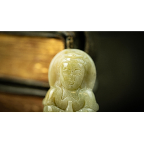 120 - AN INDIAN JADE BUDISM ORNAMENT, Carved with a serene expression, seated in dhyanasan, holding a bott... 