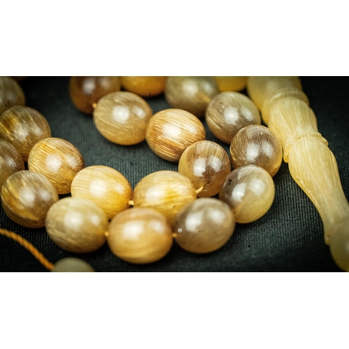 62 - The tasbih strung  with 33  spherical  beads, flat stops, narrowing and stylised elongated tulip ima... 