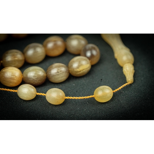 62 - The tasbih strung  with 33  spherical  beads, flat stops, narrowing and stylised elongated tulip ima... 