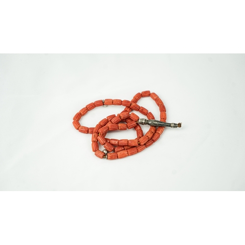 63 - CORAL PRAYER BEADS, 18TH/19TH CENTURY The strung 65 striped carved beads, two silver ball stops, sil... 