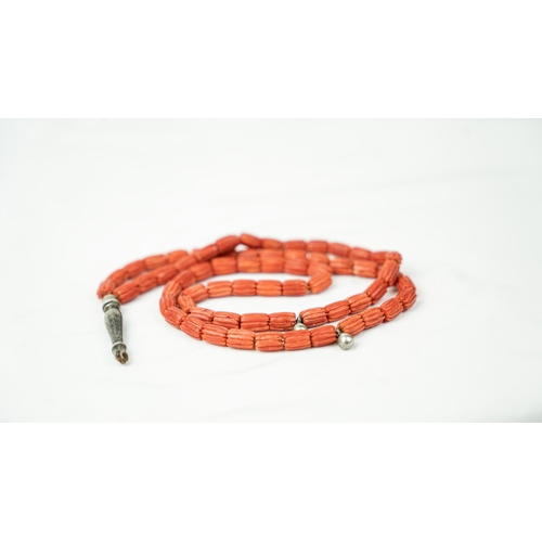 63 - CORAL PRAYER BEADS, 18TH/19TH CENTURY The strung 65 striped carved beads, two silver ball stops, sil... 