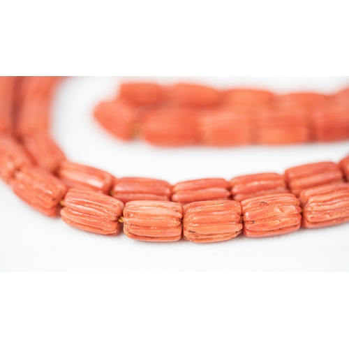 63 - CORAL PRAYER BEADS, 18TH/19TH CENTURY The strung 65 striped carved beads, two silver ball stops, sil... 