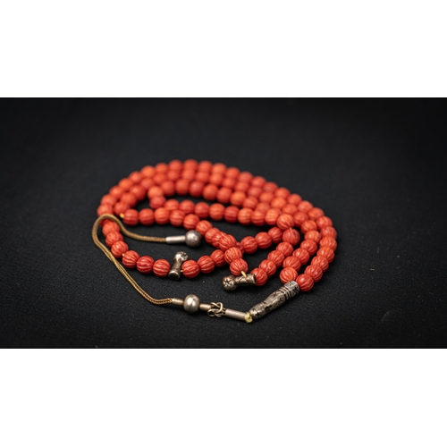 66 - CORAL PRAYER BEADS, 18TH/19TH CENTURY, The tasbih strung  with 99 spherical carved beads, silver sto... 