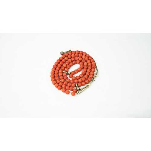 66 - CORAL PRAYER BEADS, 18TH/19TH CENTURY, The tasbih strung  with 99 spherical carved beads, silver sto... 