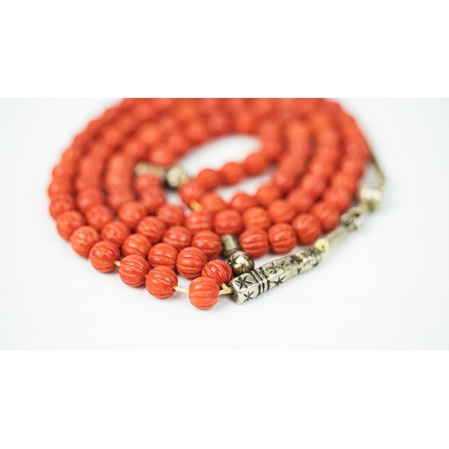 66 - CORAL PRAYER BEADS, 18TH/19TH CENTURY, The tasbih strung  with 99 spherical carved beads, silver sto... 