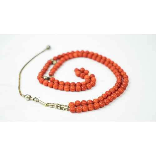 66 - CORAL PRAYER BEADS, 18TH/19TH CENTURY, The tasbih strung  with 99 spherical carved beads, silver sto... 