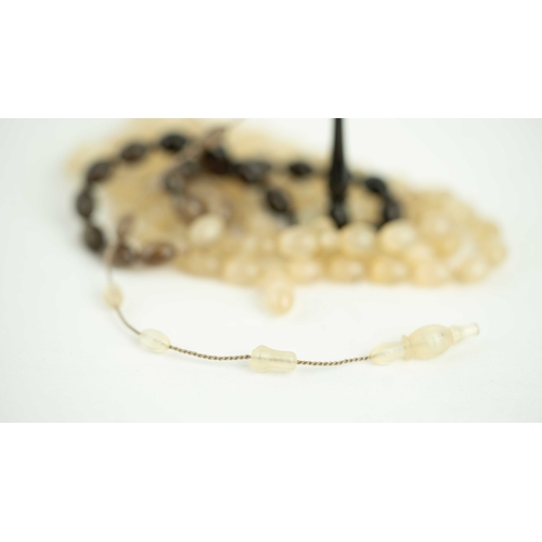 69 - The tasbih strung  with 99 ovoid  beads, larger stops, narrowing and  elongating imama,  preceeding ... 