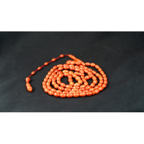 71 - A SET OF CORAL BEADS AND TURBAN FINIAL, A coral prayer beads, 99 beads for Muslim prayers, set in it... 