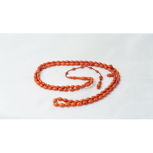 71 - A SET OF CORAL BEADS AND TURBAN FINIAL, A coral prayer beads, 99 beads for Muslim prayers, set in it... 