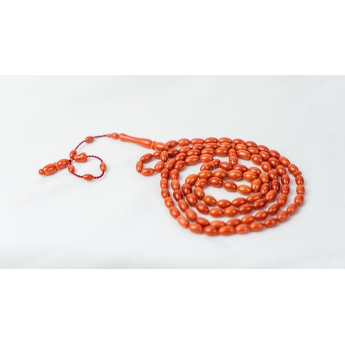 71 - A SET OF CORAL BEADS AND TURBAN FINIAL, A coral prayer beads, 99 beads for Muslim prayers, set in it... 