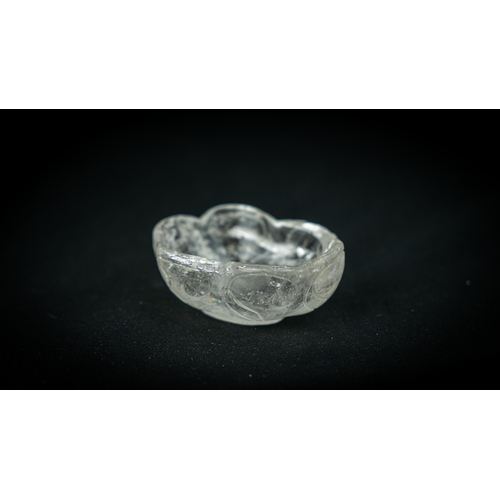 75 - A ROCK CRYSTAL TINY BOWL, Of irregular shape, resting on a flat base, with wavy rim, 100gr, 7,5 cm w... 