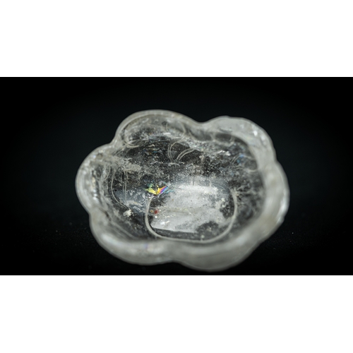 75 - A ROCK CRYSTAL TINY BOWL, Of irregular shape, resting on a flat base, with wavy rim, 100gr, 7,5 cm w... 