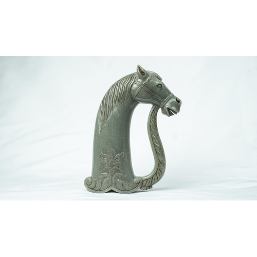 91 - A HORSE HEADED PALE GREEN JADE HILT, The hilt carved in fine green jade, in the form of a horse’s he... 