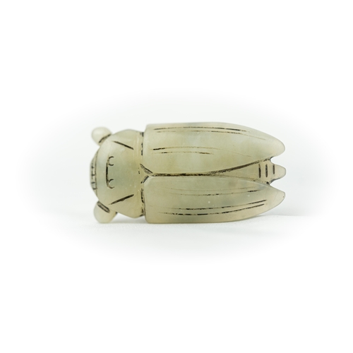 122 - A PALE GREEN CARVED JADE SCARABEE SHAPE ORNAMENT, An Egyptian green scarab, intricately carved and t... 