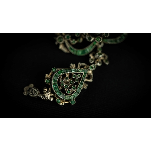 133 - A splendid vari- cut enemal brooche Early 20th century, Of open work design set with emeralds and fl... 