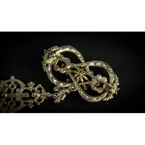 133 - A splendid vari- cut enemal brooche Early 20th century, Of open work design set with emeralds and fl... 