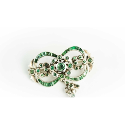 133 - A splendid vari- cut enemal brooche Early 20th century, Of open work design set with emeralds and fl... 