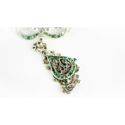 133 - A splendid vari- cut enemal brooche Early 20th century, Of open work design set with emeralds and fl... 