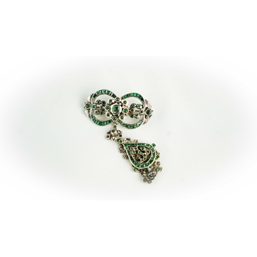 133 - A splendid vari- cut enemal brooche Early 20th century, Of open work design set with emeralds and fl... 