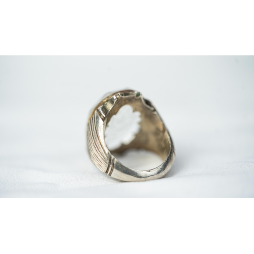 135 - A SILVER FRAMED INTAGLIO ROCK CRYSTAL RING, The oval domed rock crystal ring with Arabic inscription... 