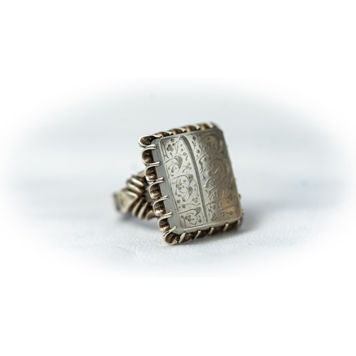 136 - AN ARABIC INSCRIPTION CARVED ROCK CRYSTAL SEAL RING, Of square form, stepped rock crystal engraved w... 